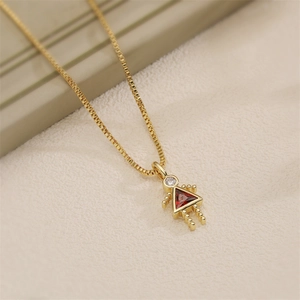 Detailed macro view of a girl pendant necklace featuring a red crystal and box chain
