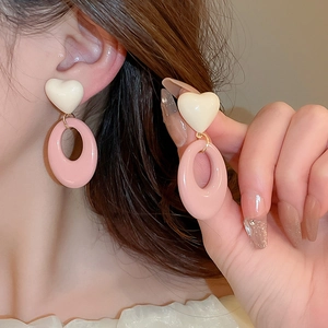 Sweet contrast resin heart and oval drop earrings shown on model for stylish look