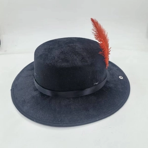 Close-up of black wool fedora featuring a silk band and a vibrant red feather accent