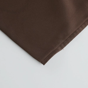 Macro detail of dark brown satin fabric showing professional stitching and smooth texture