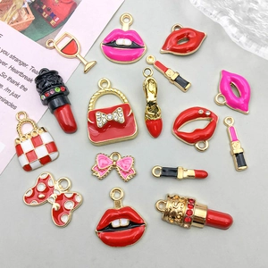 Detail of red lipstick and high heel enamel pendants with gold alloy frames and rhinestones