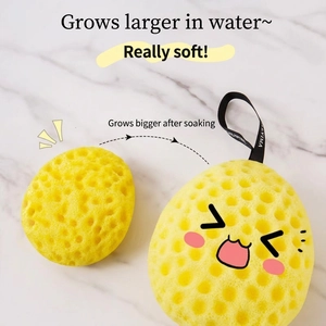 Yellow honeycomb shower sponge showing dry and wet expansion with portable hanging rope