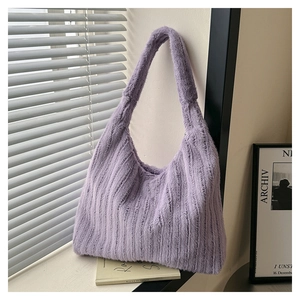Detail of soft purple plush tote bag with rich texture under natural window light