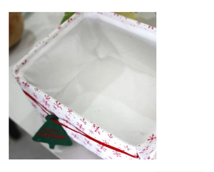 Close-up of Oxford cloth storage basket with red snowflakes and Merry Christmas tag