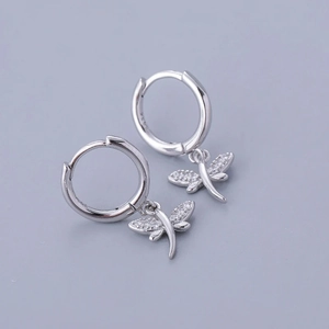 Macro shot of S925 sterling silver dragonfly hoop earrings with sparkling zircon wings