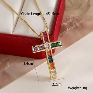 Close-up of 18K gold-plated cross pendant with vibrant multi-colored zircon stones