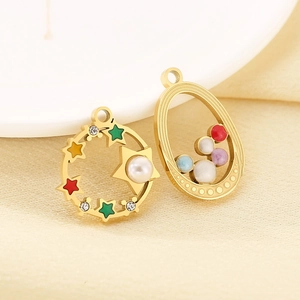 Detailed close-up of 18K gold star pendants with colorful rhinestones and pearl accents
