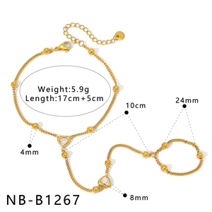 Detail of gold-plated stainless steel hand chain with heart pendant and bead accents