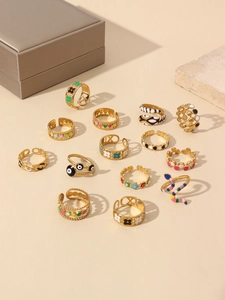 Flat lay of 18k gold plated fashion rings set with colorful enamel geometric designs