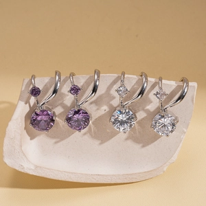 Close-up of geometric double-layer ear cuff with purple and white cubic zirconia crystals