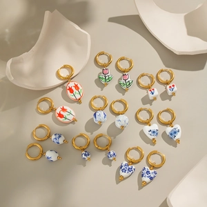 Vintage enamel ceramic flower hoop earrings with blue floral patterns and gold hooks