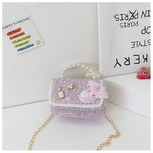 Detail of sequin girl purse with pearl handle, lace trim, and golden chain strap