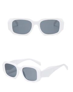 Detail view of retro white thick-frame rectangle sunglasses with dark gray lenses