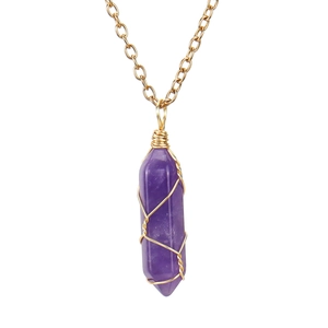 Macro detail of purple amethyst hexagonal pendant with gold wire wrapping craft