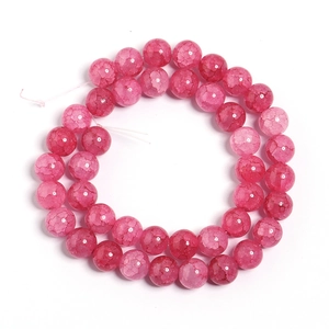 Macro detail of vibrant deep pink cracked glass beads for DIY jewelry making