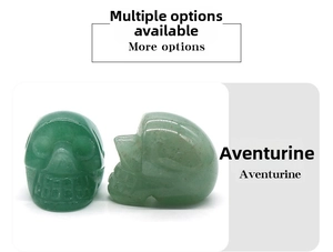 Detail of hand-carved green aventurine crystal skulls showing fine craftsmanship and texture