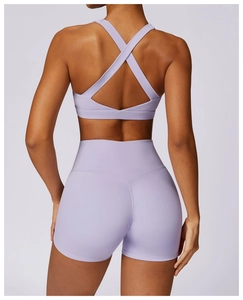 Rear view of lilac quick-dry yoga set showing cross-back sports bra and high-waist shorts
