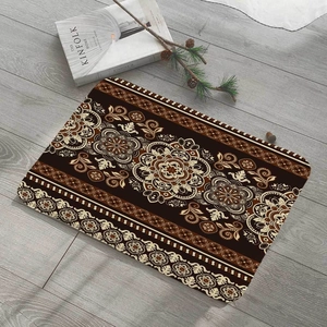 Detail of a square flannel floor mat with ethnic mandala patterns on wooden flooring