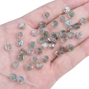 Macro view of iridescent glass rose beads for handmade DIY jewelry crafting and accessories