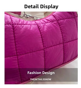 Detail shot of bright pink quilted crossbody bag with silver chain and puffy texture