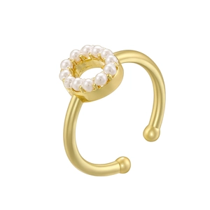 Detailed macro view of an elegant gold ring with a circular pearl-encrusted setting