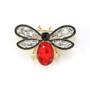 Detailed view of a cute honey bee brooch featuring a large red faceted gemstone abdomen