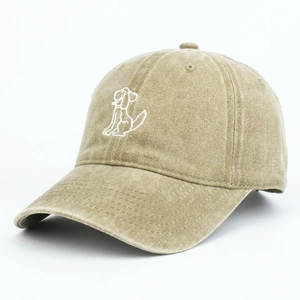 Detailed embroidery of a white puppy outline on a vintage khaki cotton baseball cap