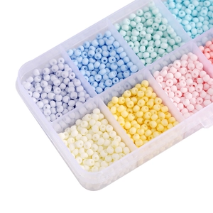 Macro view of macaron glass seed bead set in a transparent multi-grid organizer box