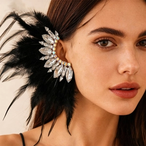 Detailed view of bohemian ear cuff with black feathers and sparkling crystals on model