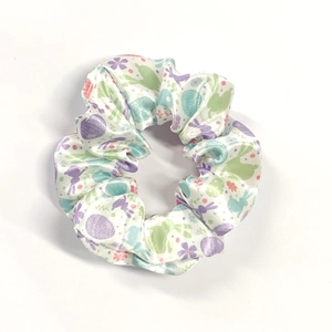 Easter scrunchie with pastel bunny and egg patterns on white silk-textured fabric