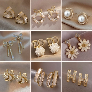 Detail of nine s925 silver star and pearl tassel earrings with gold plating finish