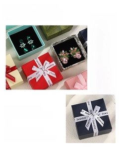 Close-up of premium jewelry gift boxes with satin ribbon and black velvet lining