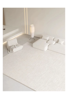 Top view of large cream woven area rug in modern living room with minimalist white sofa