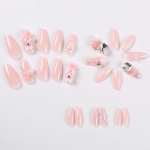 Detailed view of pink glossy press-on nails with 3D rabbits, pearls and floral designs