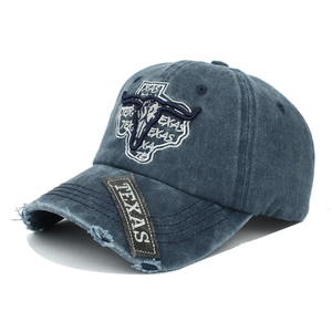 Detail of vintage washed baseball cap with Texas embroidery and distressed brim edge