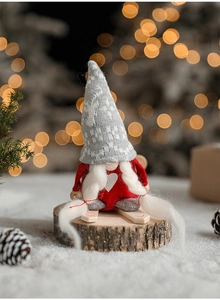 Close-up of a festive Christmas gnome on wooden base with knit hat and ski details