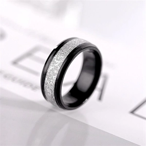 Macro shot of men's black titanium ring featuring silver-gray frost texture inlay