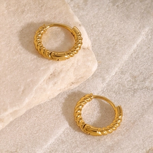 Classic 18k gold plated stainless steel twisted rope hoop earrings on a marble stone
