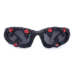 Gothic punk sunglasses featuring a black melting frame with red demon eye details