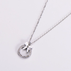 Elegant silver bow pendant necklace with sparkling crystal ring on white background