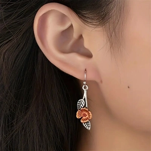 Retro leaf and orange flower drop earrings with silver hooks for a minimalist nature style