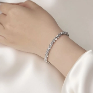 Elegant 18k gold plated beaded bracelet with laser-cut texture shown on woman's wrist