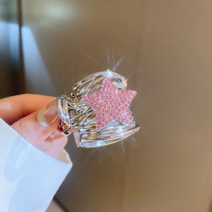 Close-up of pink rhinestone star hair claw clip with silver metal and sparkling accents