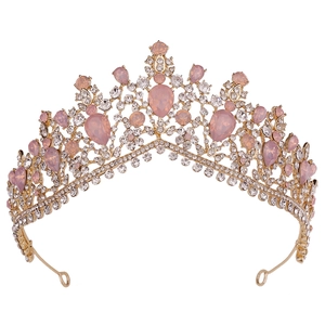 Detailed view of Baroque gold crown featuring pear-shaped pink gems and sparkling rhinestones