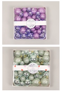 Detailed close-up of purple and light green Christmas balls in shiny and matte finishes