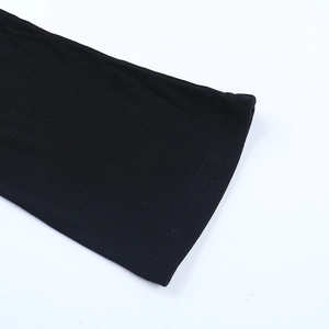 Detail of double-stitched hem on a black V-neck dress showing fine knit texture