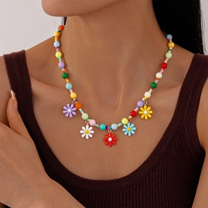 Colorful acrylic beaded necklace with flower charms worn by a model for a fresh look