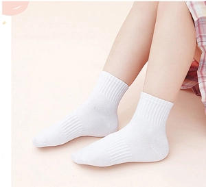 Close-up of white cotton crew socks for kids shown on model with breathable knit texture