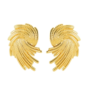 Macro detail of gold spiral earrings with intricate beaded texture and radial line design
