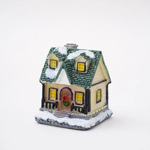 Lighted resin Christmas village house with snow effect and miniature holiday wreath decor